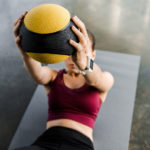 woman doing exercise with medicine ball