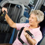 Senior lady on exercise machine